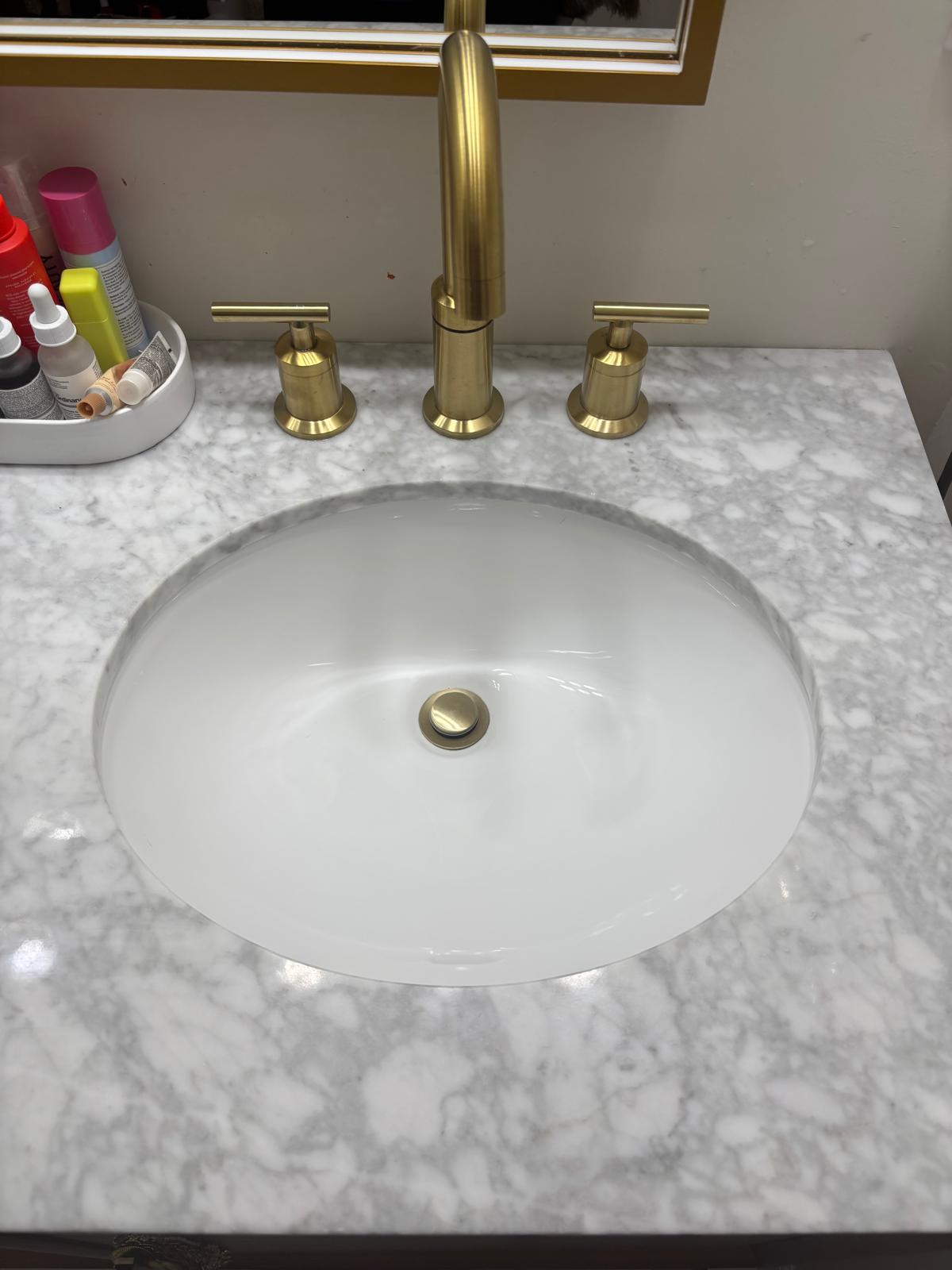 The same bathroom sink and marble vanity after cleaning